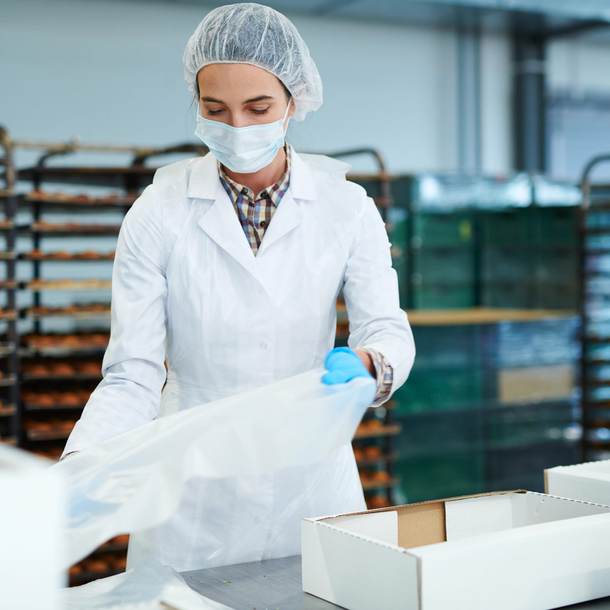 woman packing boxes at a commercial bakery